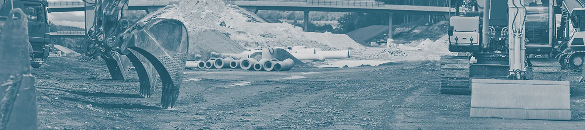 A photo of a construction site with cranes in the background.